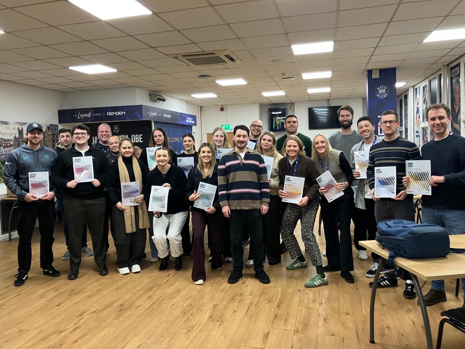 Staff holding their Spotlight profiles at a Premiership rugby club session